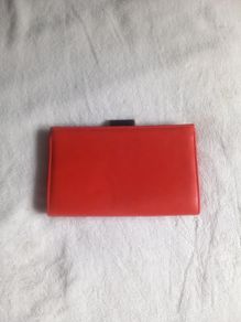 orange clutch Next