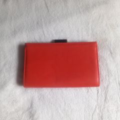orange clutch Next