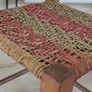 Antique wooden footstool with woven seat Image 2