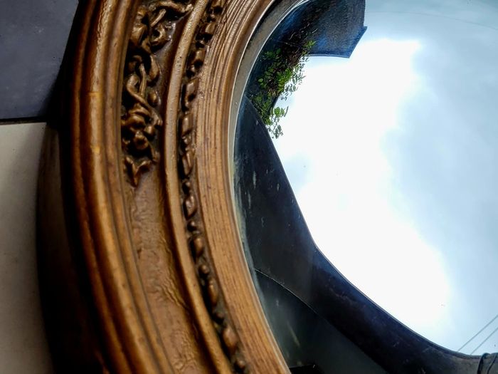 Antique gilt wood floral motif convex mirror