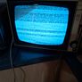 Ideal Prop, Vintage Working Boots Audio TV12 Portable Black and White CRT Television, featuring a cream plastic casing with side control dials and a 12 inch screen. Designed with dual power capabilities supporting standard mains voltage (240V) as well as  Image 3