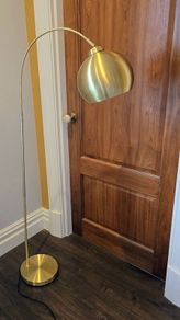 Gold arc free standing lamp