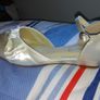 Brand new, never worn ivory satin wedge shoe with satin bow detail. Image 2