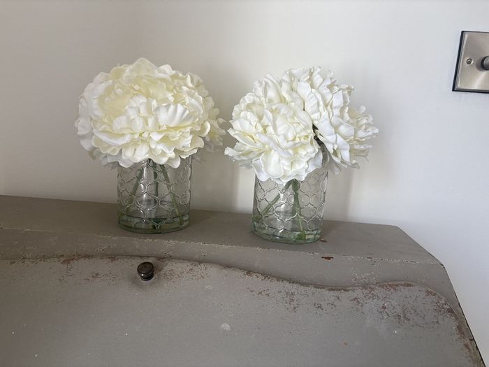 Pair of faux floral decorations with glass vases