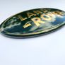 LAND ROVER Defender SVX Green and Yellow (gold) letters GRILL OVAL BADGE 105mm - 53mm 105  53 Image 2