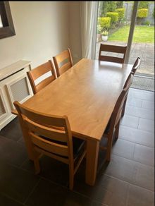 Solid wood dining table. Damage on corner as shown in photos.