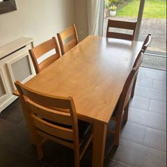 Solid wood dining table. Damage on corner as shown in photos.