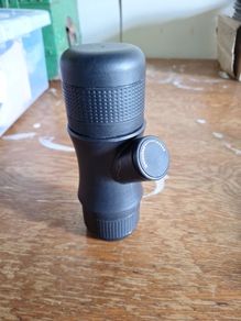 Handheld and hand operated portable espresso maker