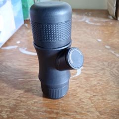 Handheld and hand operated portable espresso maker