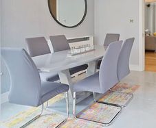 Glass-topped dining table with 6 chairs