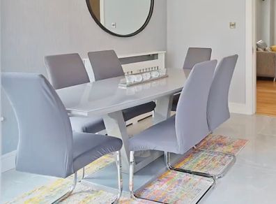 Glass-topped dining table with 6 chairs