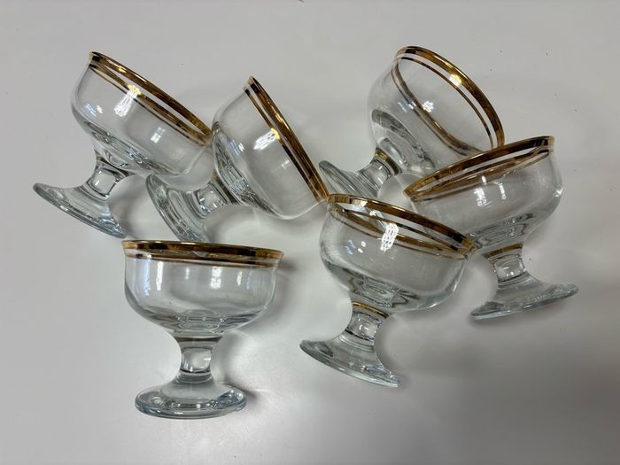 Set of six clear glass footed dessert dishes with gold-trimmed rims