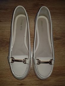 Kurt Geiger flat cream patent shoes.