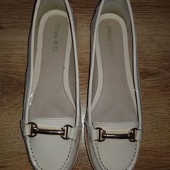 Kurt Geiger flat cream patent shoes.
