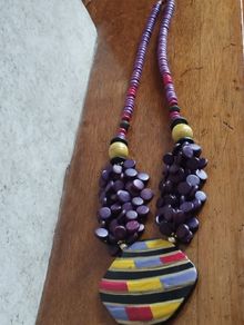 Vintage spectacular necklace made of wooden beads and medallion.