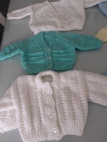 New baby cardigans size 0/3months .2 blue 1yellow 1green 2 white and 2 blue  hats .All new .Hand knit .