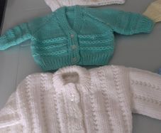 New baby cardigans size 0/3months .2 blue 1yellow 1green 2 white and 2 blue  hats .All new .Hand knit .