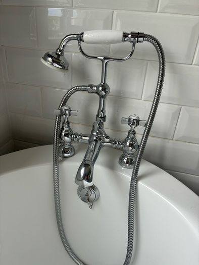 free standing bath with taps and and hose