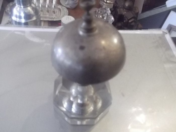 a antique counter bell with a cut glass base