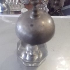 a antique counter bell with a cut glass base