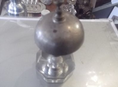 a antique counter bell with a cut glass base