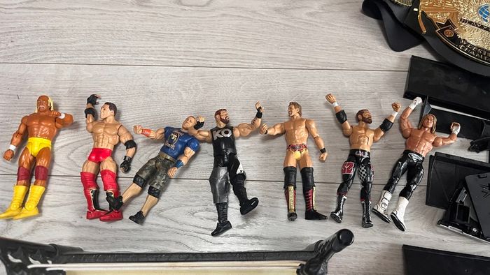 WWE wrestling ring with figures and championship belt