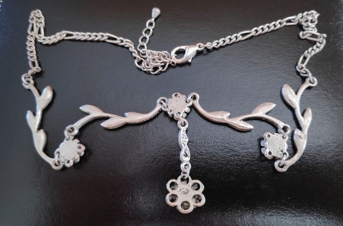 Silver tone floral necklace with red gemstone style accents