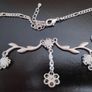 Silver tone floral necklace with red gemstone style accents Image 3