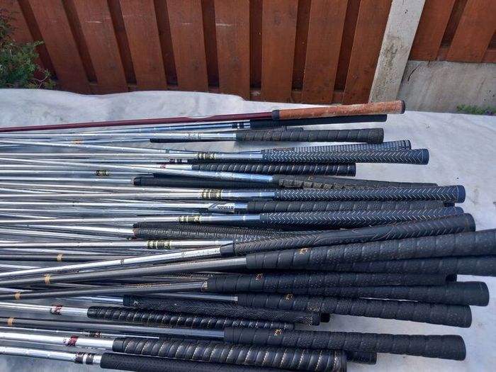 A selection of Golf clubs. Bags and golf balls.