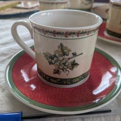 Vintage Villeroy and Boch coffee cups and saucers in Festive Memories pattern.