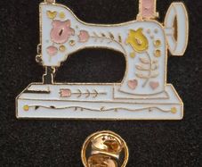 Sewing machine, pin back badge.