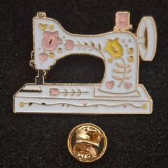 Sewing machine, pin back badge.
