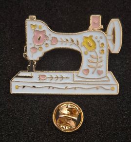 Sewing machine, pin back badge.