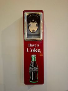 Vintage Coca-Cola wall-mount bottle opener and cap catcher