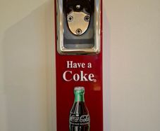 Vintage Coca-Cola wall-mount bottle opener and cap catcher