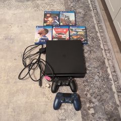 PlayStation 4 with 5 games and 2 controllers
