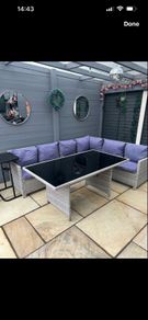 L shaped rattan sofa and glass top table
