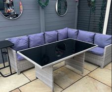 L shaped rattan sofa and glass top table