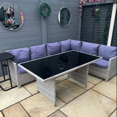 L shaped rattan sofa and glass top table