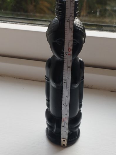Vintage miniature "VUDU" bottle made of opaque black glass.