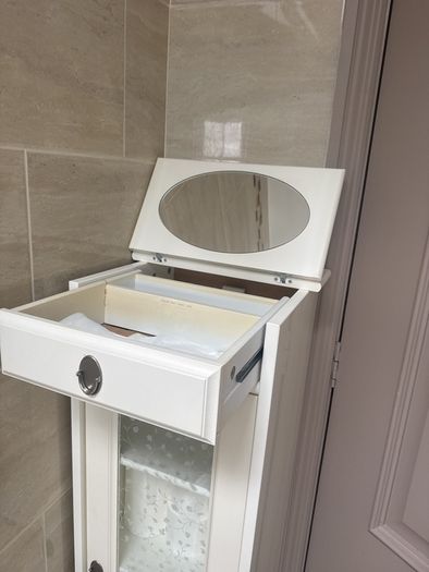Bathroom storage in white.