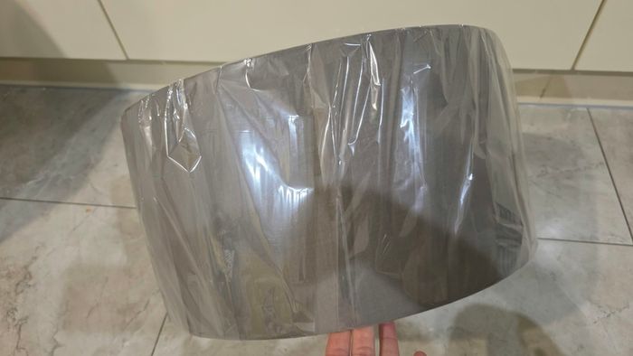 Brand new grey drum lampshade still sealed in its original plastic wrapping.