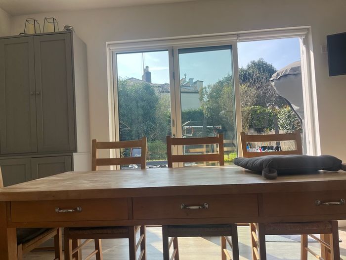 Solid oak dining table and 8 chairs with storage drawers