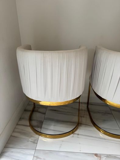 Cream and gold armchairs