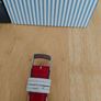 Tommy Hilfiger watch features a distinctive rectangular stainless steel case and a reversible red, white, and blue leather strap Image 5