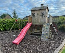 Treehouse with swings, slide and picnic table