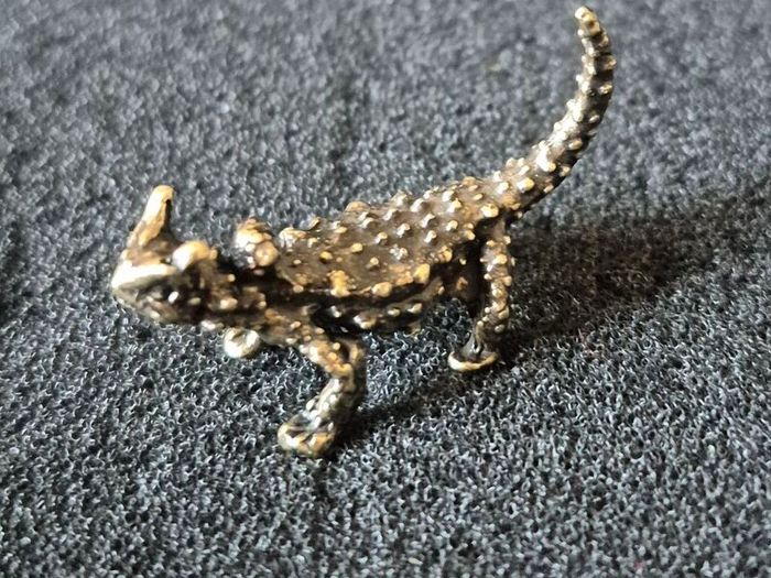 3 brass lizards.