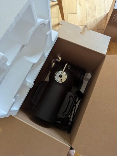 Nespresso coffee machine with lavazza frother and coffee pod stand