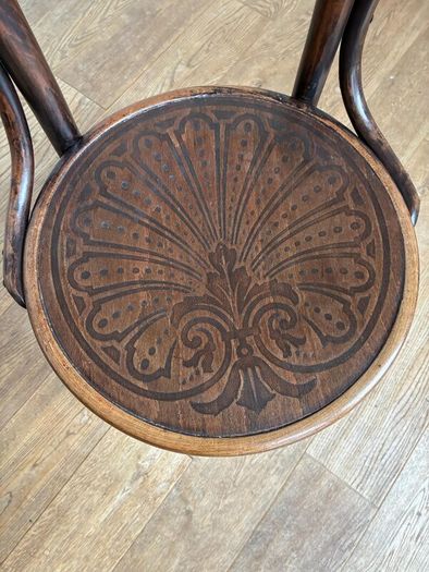 A vintage 1920s Thonet style bentwood chair with armrests.