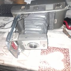 Vintage Large Polaroid Electric Eye Land Camera Model 900, Manufacture between 1960 and 1963. Key Features: Top of the line automatic shutter model featuring a folding bellows design and electric eye light metering